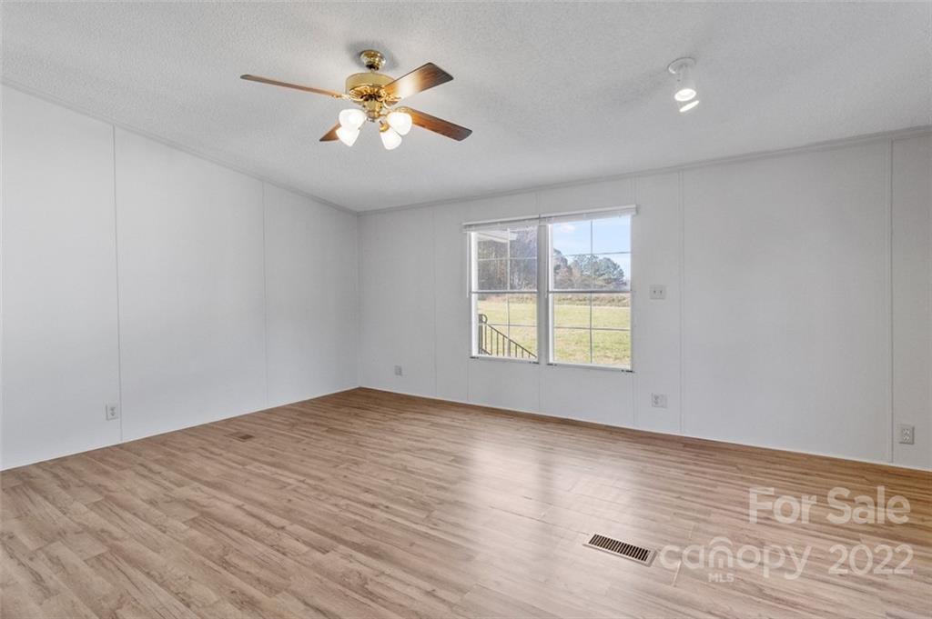 7237 Long Island Road Catawba, NC 28609 - Photo 14 of 36 an empty room with wooden floor and windows