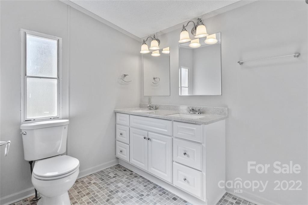 7237 Long Island Road Catawba, NC 28609 - Photo 17 of 36 a bathroom with a toilet sink and mirror