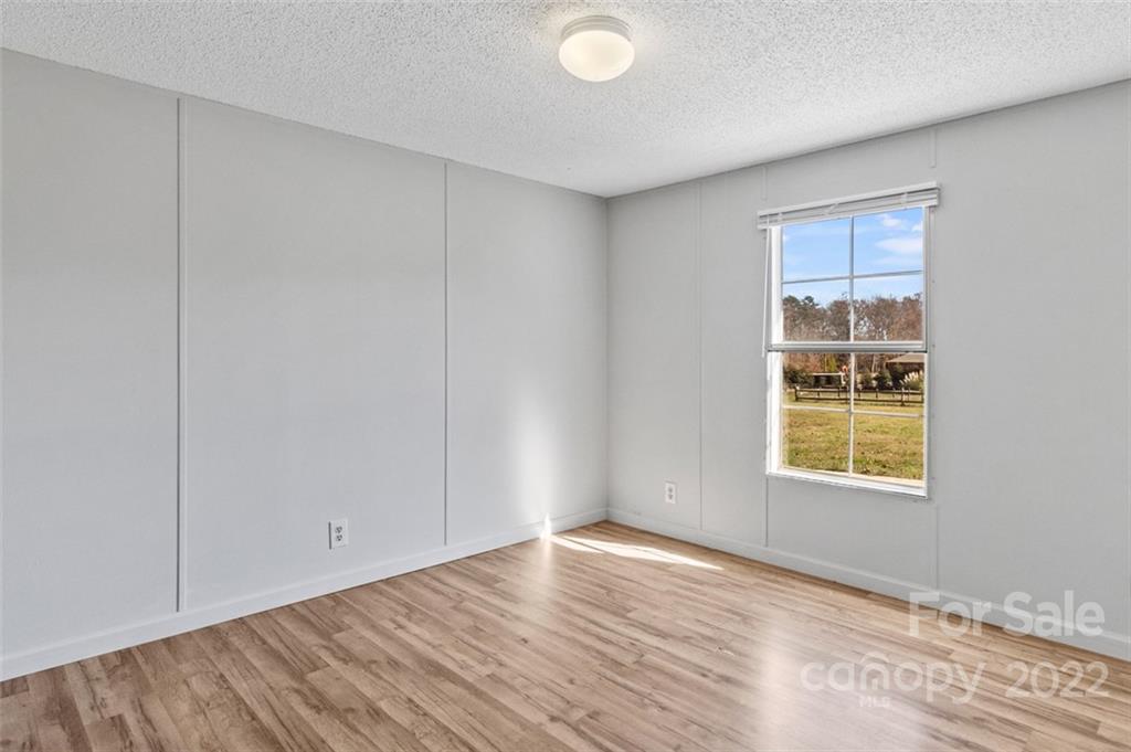 7237 Long Island Road Catawba, NC 28609 - Photo 22 of 36 a view of an empty room with wooden floor and a window