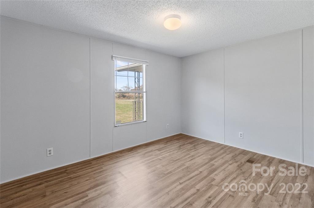 7237 Long Island Road Catawba, NC 28609 - Photo 24 of 36 wooden floor in an empty room with a window