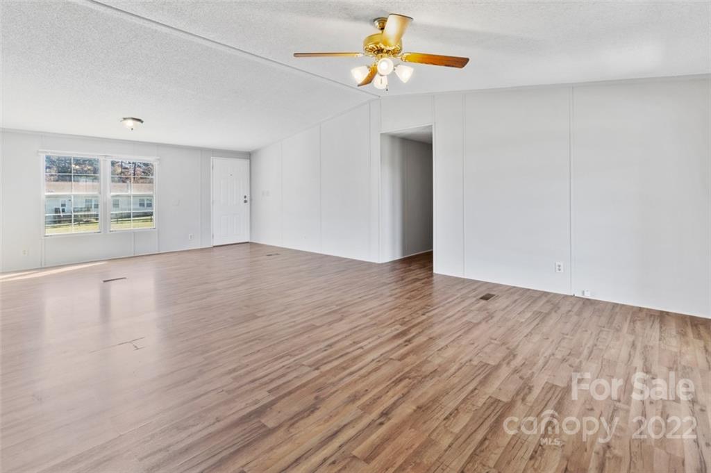 7237 Long Island Road Catawba, NC 28609 - Photo 7 of 36 an empty room with wooden floor and windows