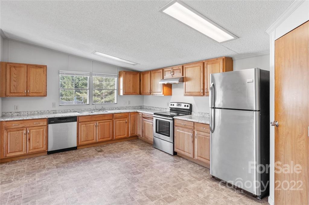 7237 Long Island Road Catawba, NC 28609 - Photo 10 of 36 a kitchen with granite countertop stainless steel appliances a refrigerator sink and microwave