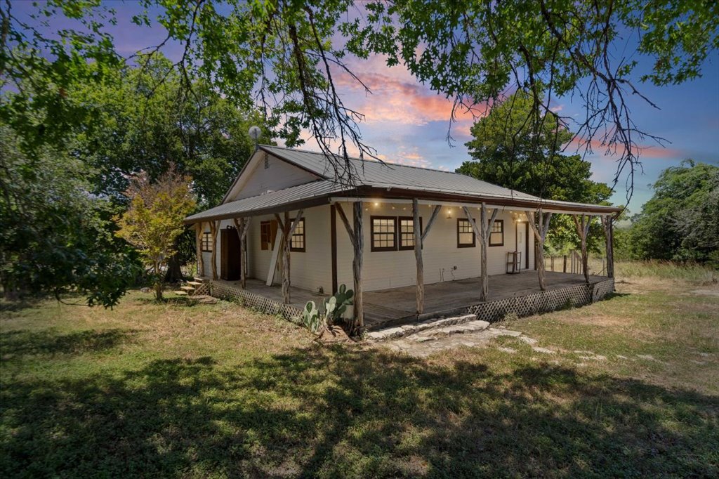 555 Harmon Hills Road, Unit A Dripping Springs, TX 78620 - Photo 9 of 29 A charming country retreat features a wide, covered porch, perfect for relaxing evenings.