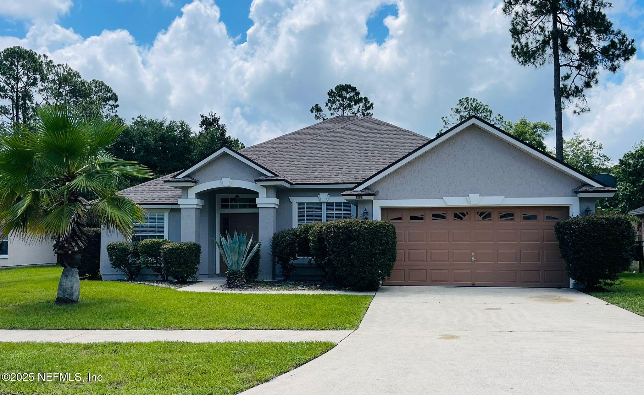 2933 Turning Leaf Lane Jacksonville, FL 32221 - Photo 1 of 22 a front view of a house with a garden