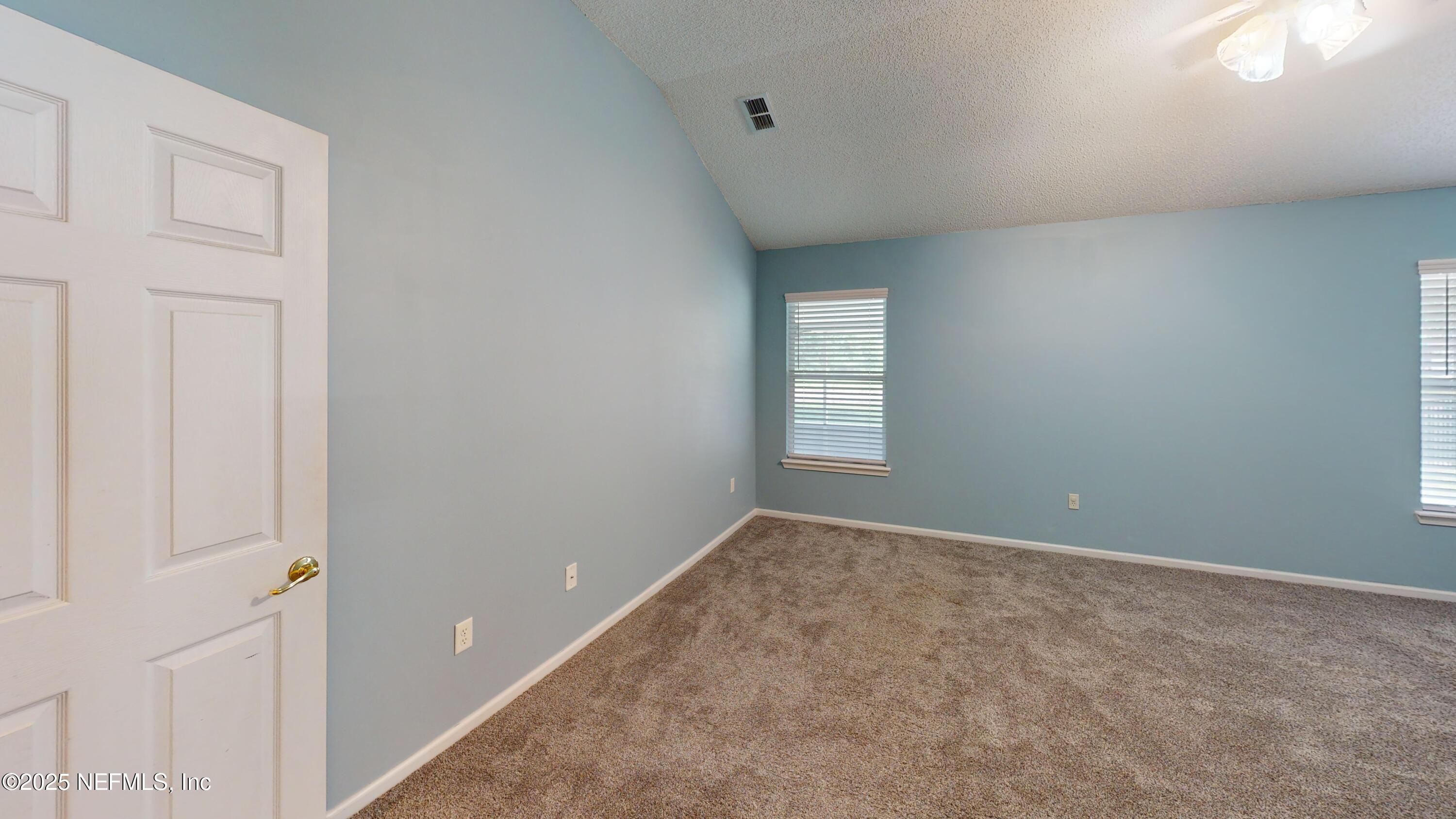 2933 Turning Leaf Lane Jacksonville, FL 32221 - Photo 13 of 22 an empty room with windows and closet