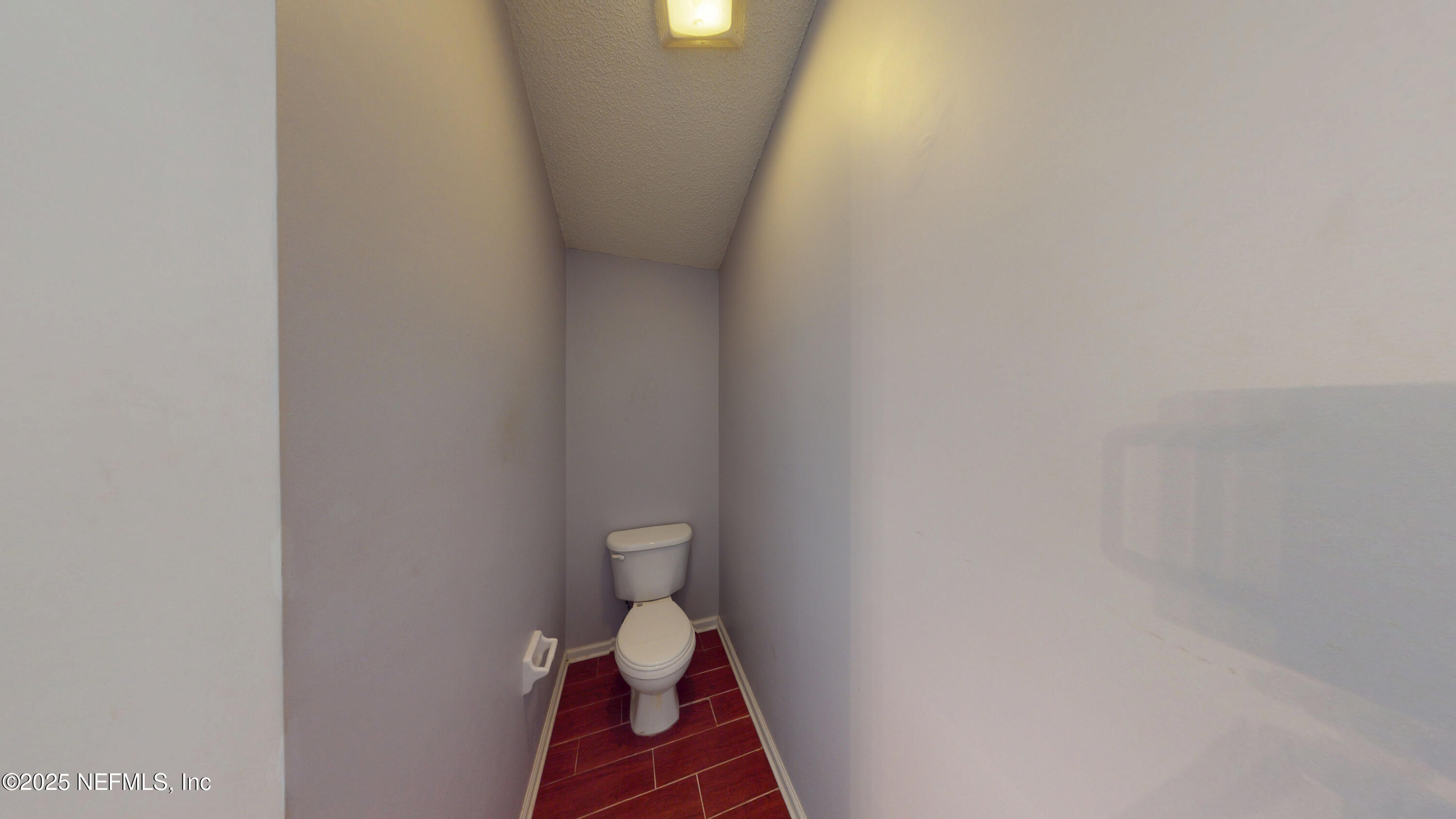 2933 Turning Leaf Lane Jacksonville, FL 32221 - Photo 17 of 22 a bathroom with a toilet and a shower curtain