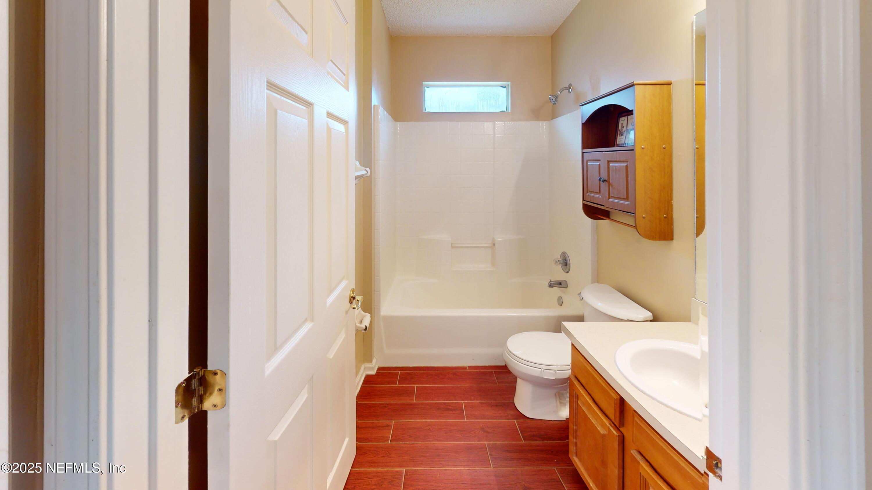 2933 Turning Leaf Lane Jacksonville, FL 32221 - Photo 20 of 22 a bathroom with a toilet a sink and a bathtub