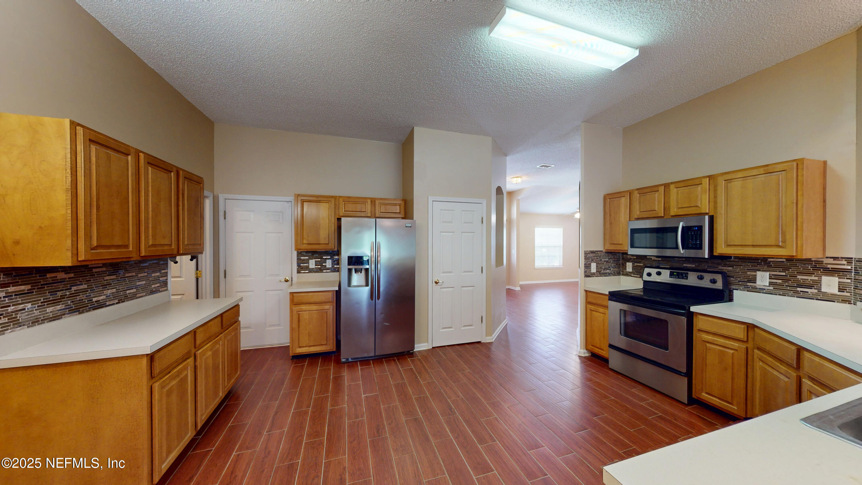 2933 Turning Leaf Lane Jacksonville, FL 32221 - Photo 2 of 22 a kitchen with stainless steel appliances wooden floor and a sink