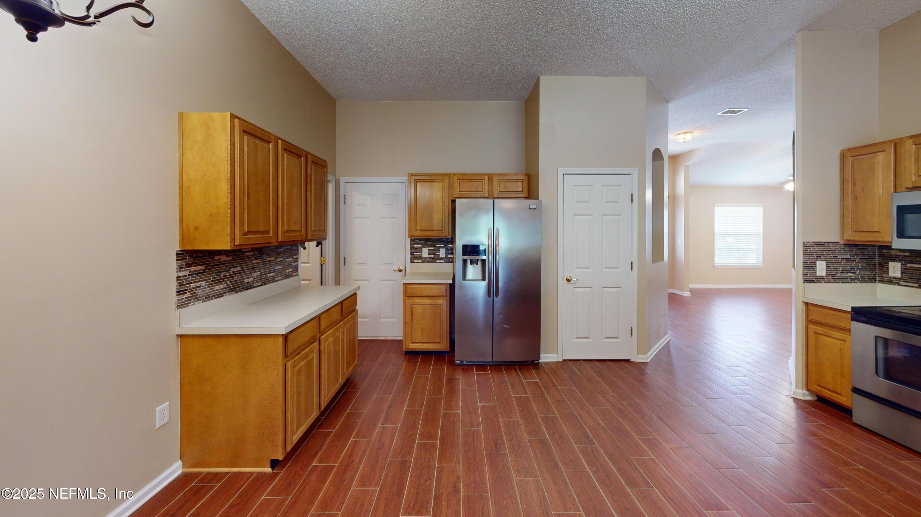 2933 Turning Leaf Lane Jacksonville, FL 32221 - Photo 4 of 22 a kitchen with stainless steel appliances granite countertop a stove and a refrigerator