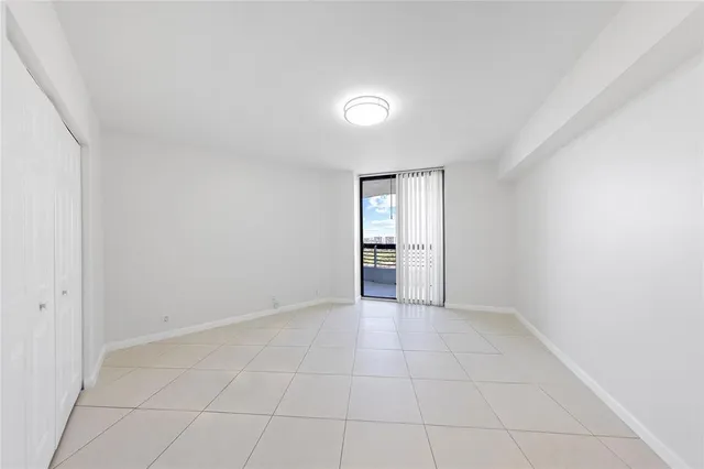 a view of a hallway with wooden floor and chandelier