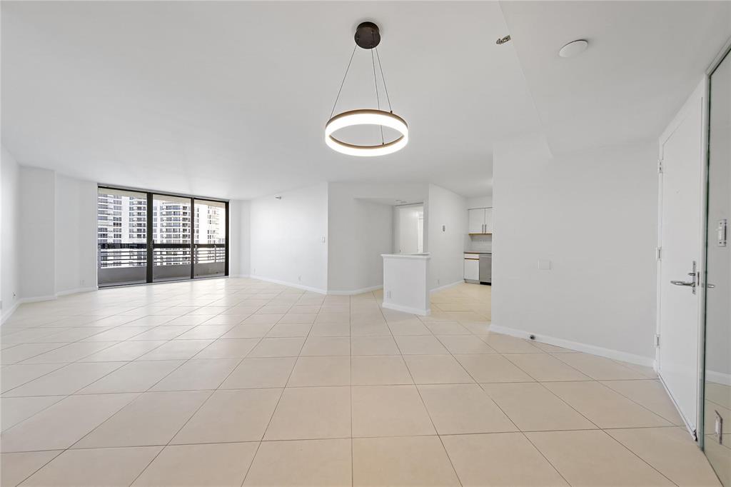 3530 Mystic Pointe Drive, Unit 2707 Aventura, FL 33180 - Photo 5 of 11 a view of an empty room with a window