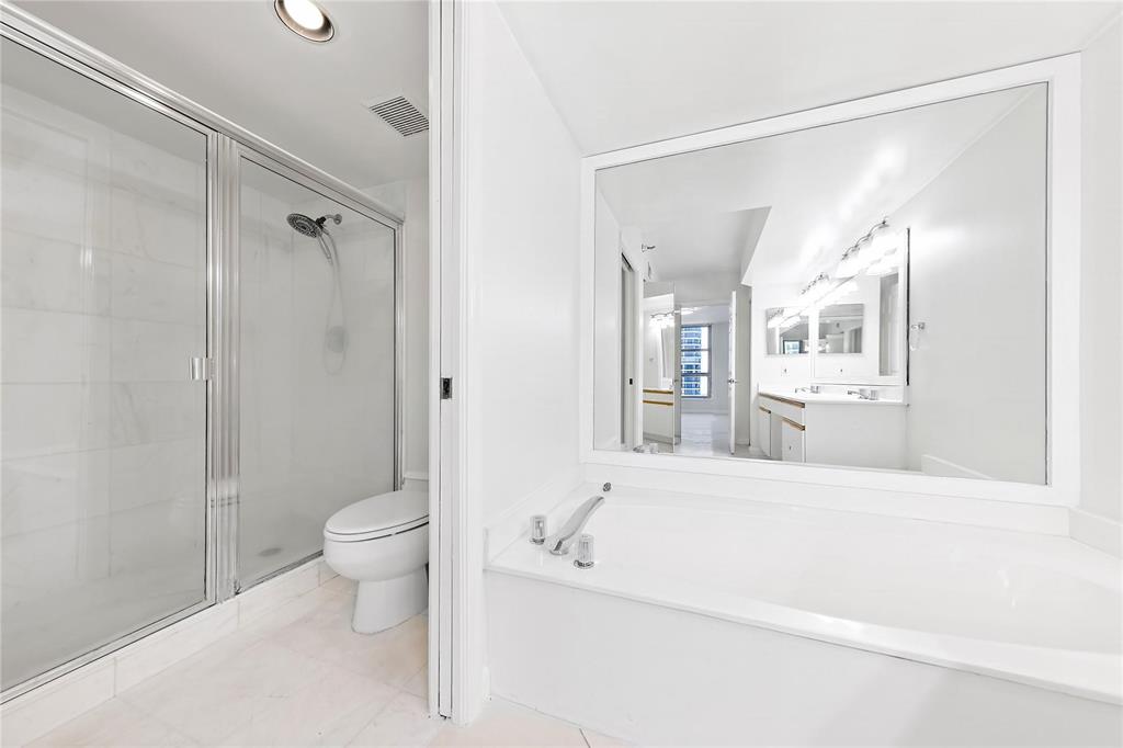 3530 Mystic Pointe Drive, Unit 2707 Aventura, FL 33180 - Photo 6 of 11 a bathroom with a toilet a sink and a bathtub