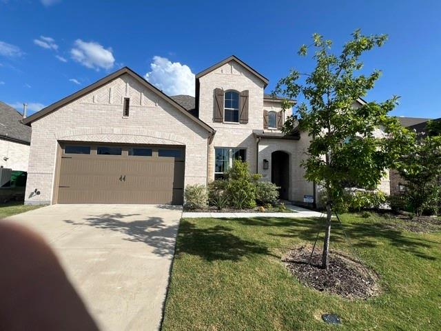 1407 Cartona Road Fate, TX 75087 - Photo 1 of 21 Light-colored brick exterior featuring a multi-gabled roofline and an arched entryway