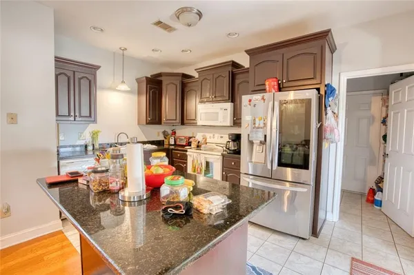a kitchen with stainless steel appliances granite countertop a refrigerator and stove