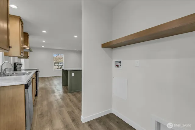 a view of a kitchen with a refrigerator and a sink