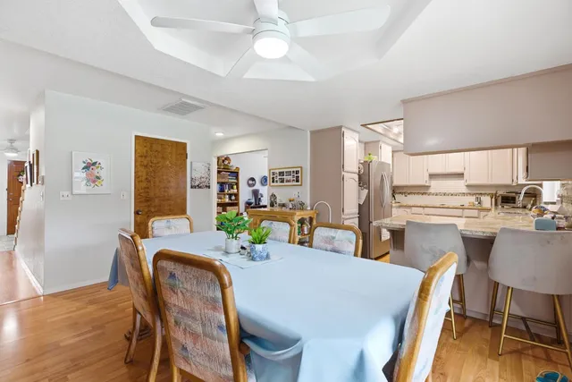 a dining room with furniture and a kitchen view