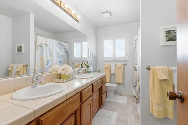 a bathroom with a sink double vanity and a mirror