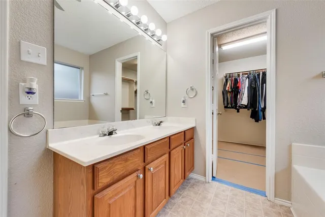 a bathroom with a sink a vanity a mirror and shower