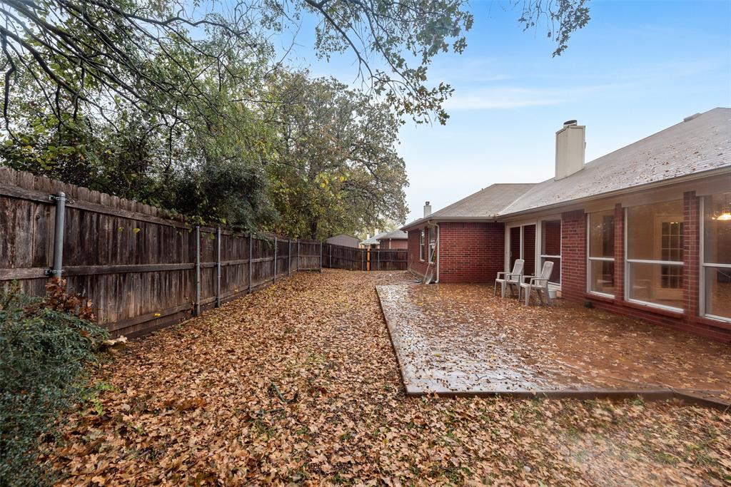 617 Madeline Court Azle, TX 76020 - Photo 18 of 20 Fenced backyard with a patio area