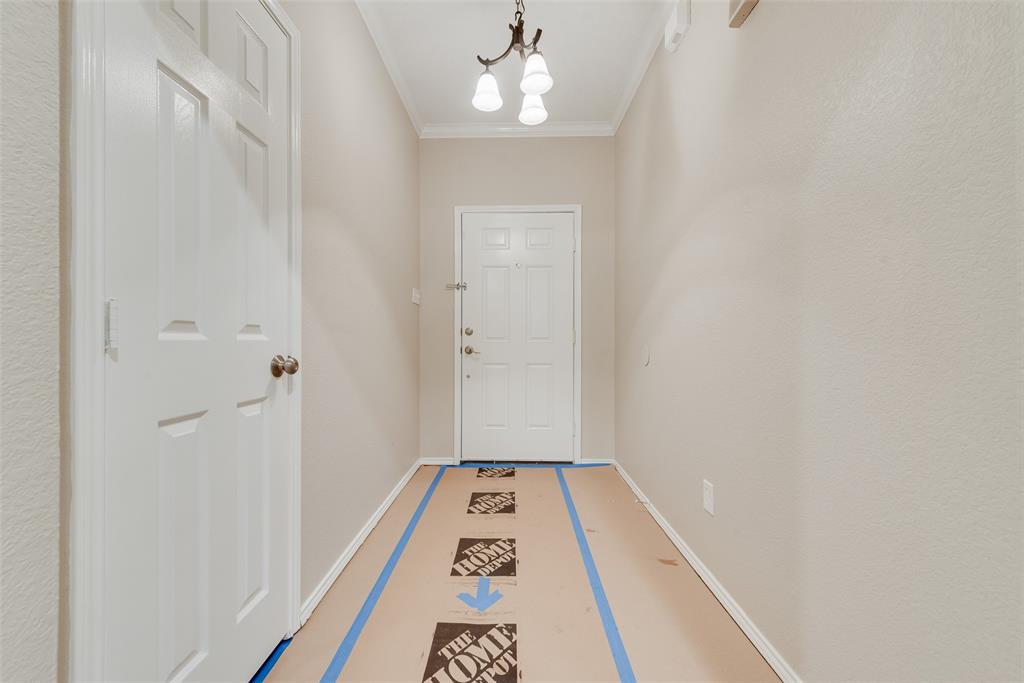 617 Madeline Court Azle, TX 76020 - Photo 3 of 20 Entryway with a chandelier and crown molding