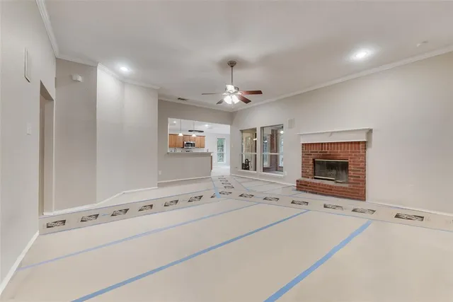 a view of an empty room with a fireplace and a window