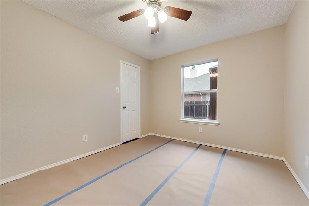 617 Madeline Court Azle, TX 76020 - Photo 9 of 20 Unfurnished room featuring a textured ceiling and a ceiling fan
