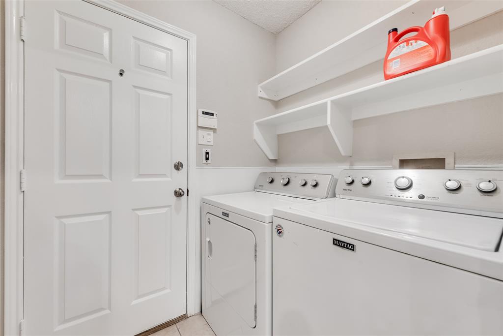 617 Madeline Court Azle, TX 76020 - Photo 10 of 20 Washroom featuring washing machine and clothes dryer, a textured ceiling, and light tile patterned flooring
