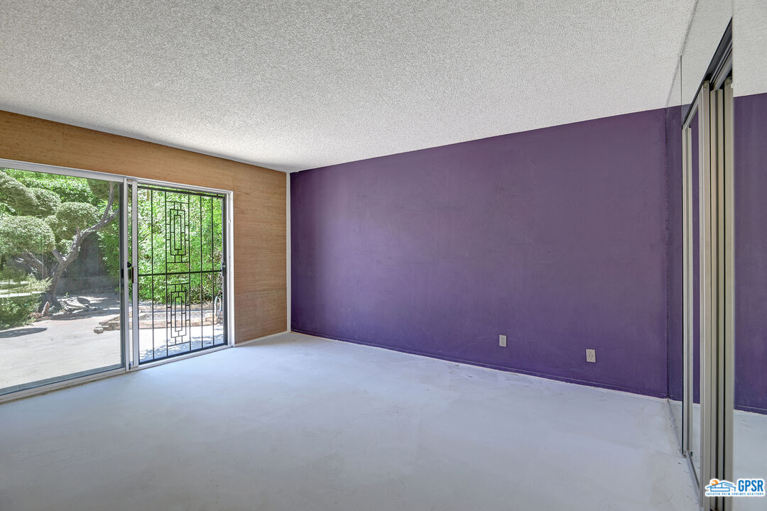 2189 East Sonora Road Palm Springs, CA 92264 - Photo 16 of 29 an empty room with wooden floor and windows