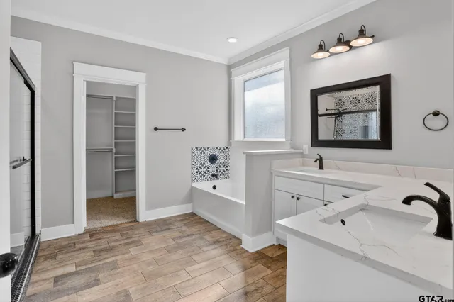 a bathroom with a double vanity sink and a mirror