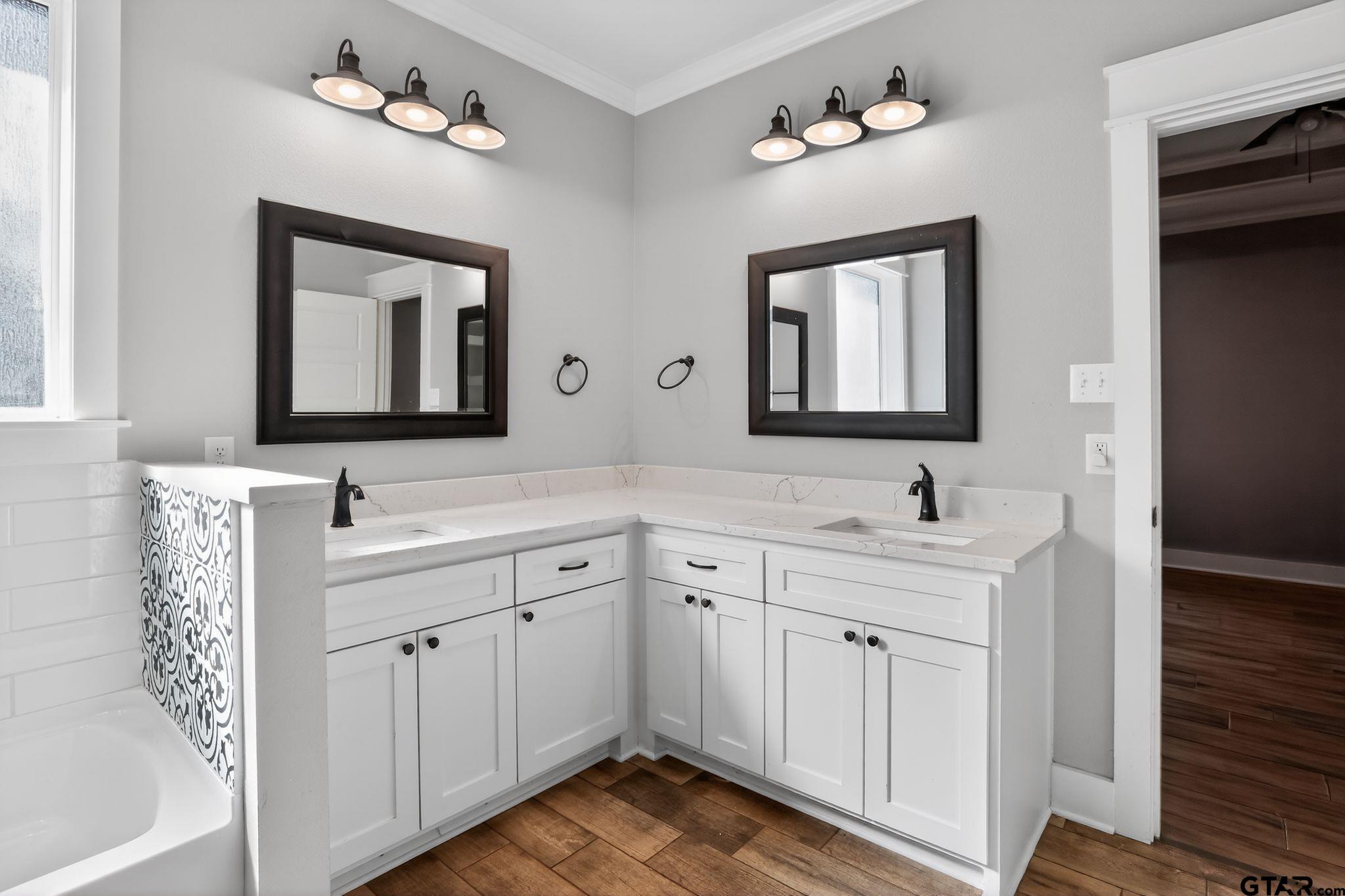 7600 County Road 210 Tyler, TX 75702 - Photo 22 of 30 a bathroom with a double vanity sink and a mirror