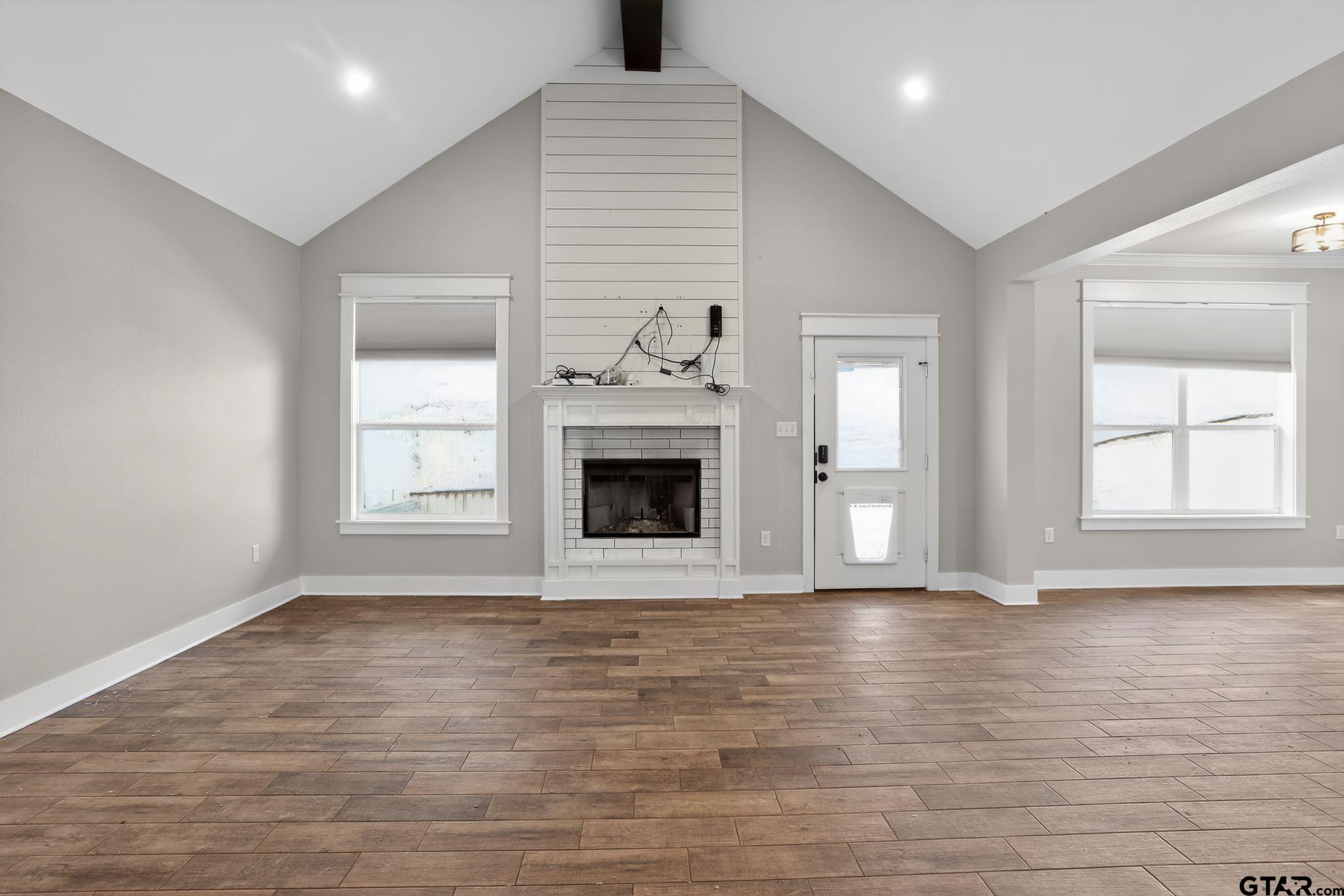 7600 County Road 210 Tyler, TX 75702 - Photo 6 of 30 a view of an empty room with glass door and wooden floor
