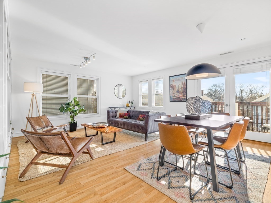 2 Boylston Street, Unit 4 Boston, MA 02130 - Photo 3 of 30 a dining room with furniture a chandelier and wooden floor