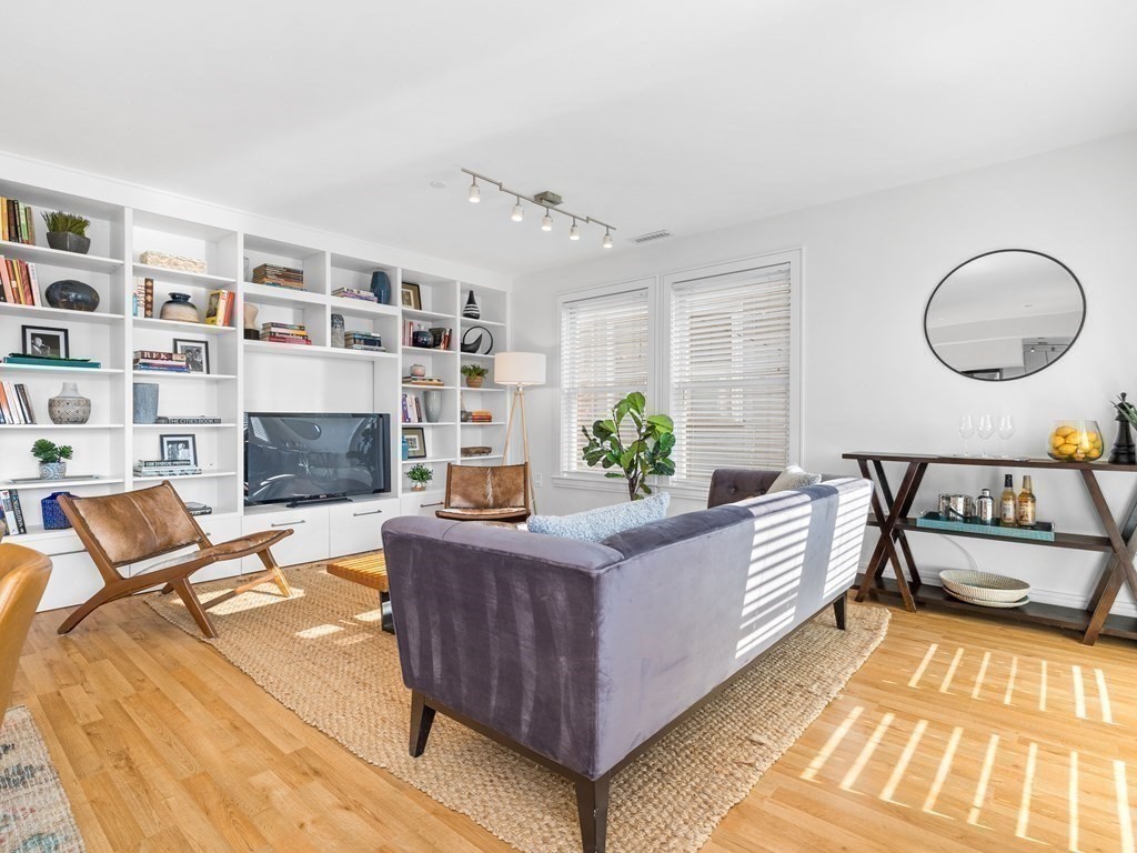 2 Boylston Street, Unit 4 Boston, MA 02130 - Photo 4 of 30 a living room with furniture and a fireplace