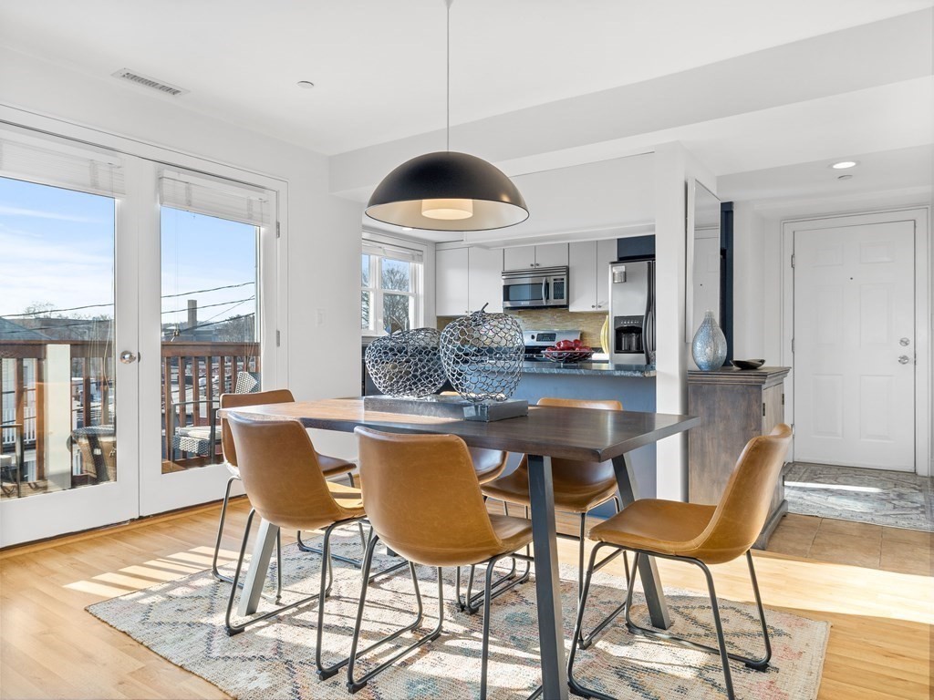 2 Boylston Street, Unit 4 Boston, MA 02130 - Photo 7 of 30 a kitchen with a dining table chairs and a coffee table