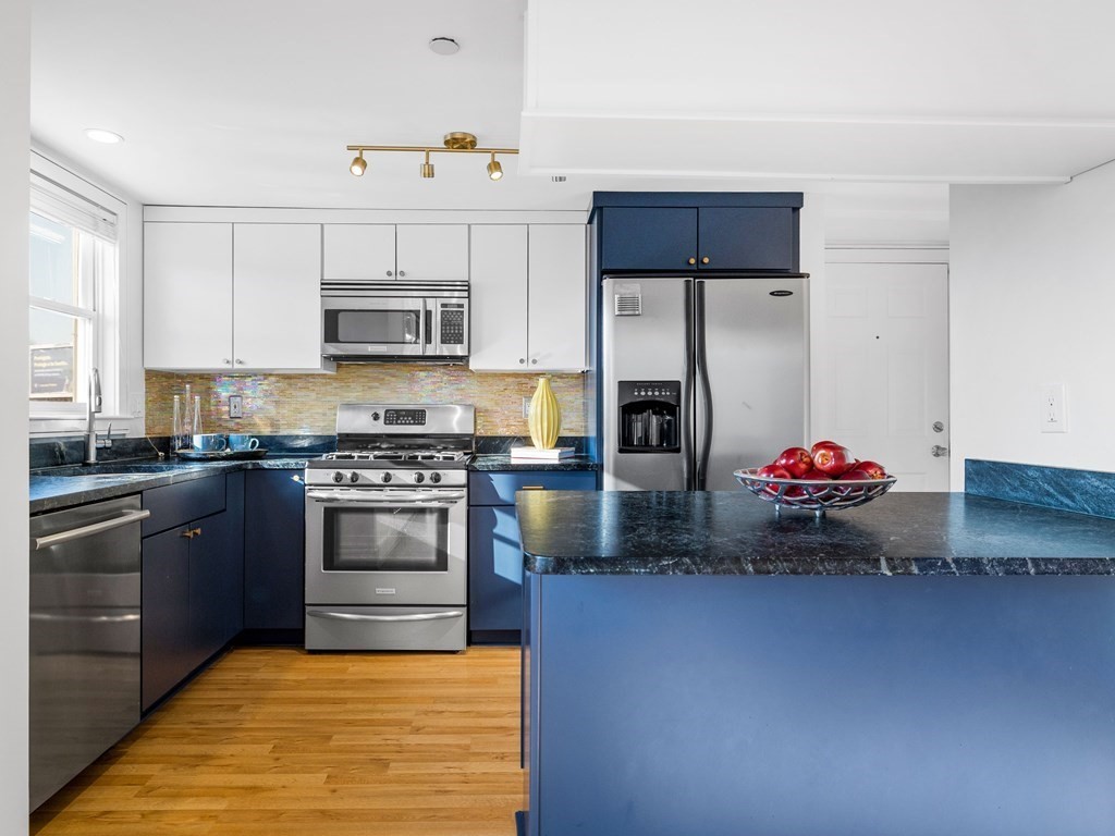 2 Boylston Street, Unit 4 Boston, MA 02130 - Photo 10 of 30 a kitchen with stainless steel appliances granite countertop a stove a sink and a refrigerator