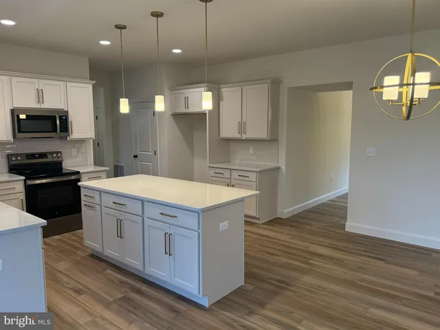 a kitchen with a stove window and wooden floor