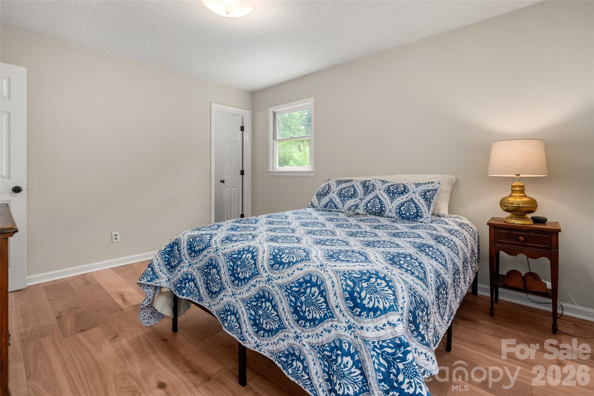5219 New Town Road Waxhaw, NC 28173 - Photo 20 of 35 a bedroom with a bed and a lamp