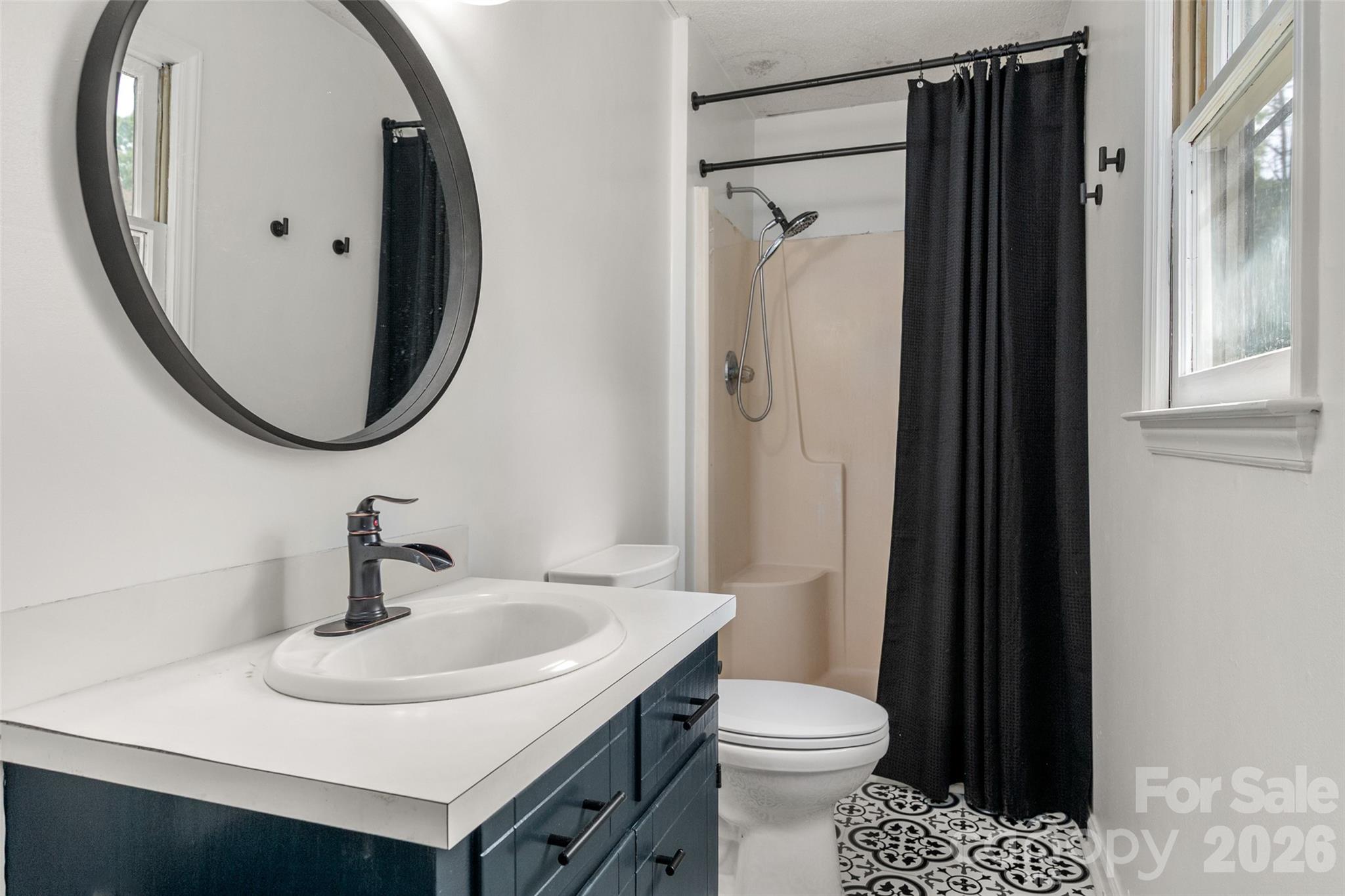 5219 New Town Road Waxhaw, NC 28173 - Photo 22 of 35 a bathroom with a sink toilet and shower