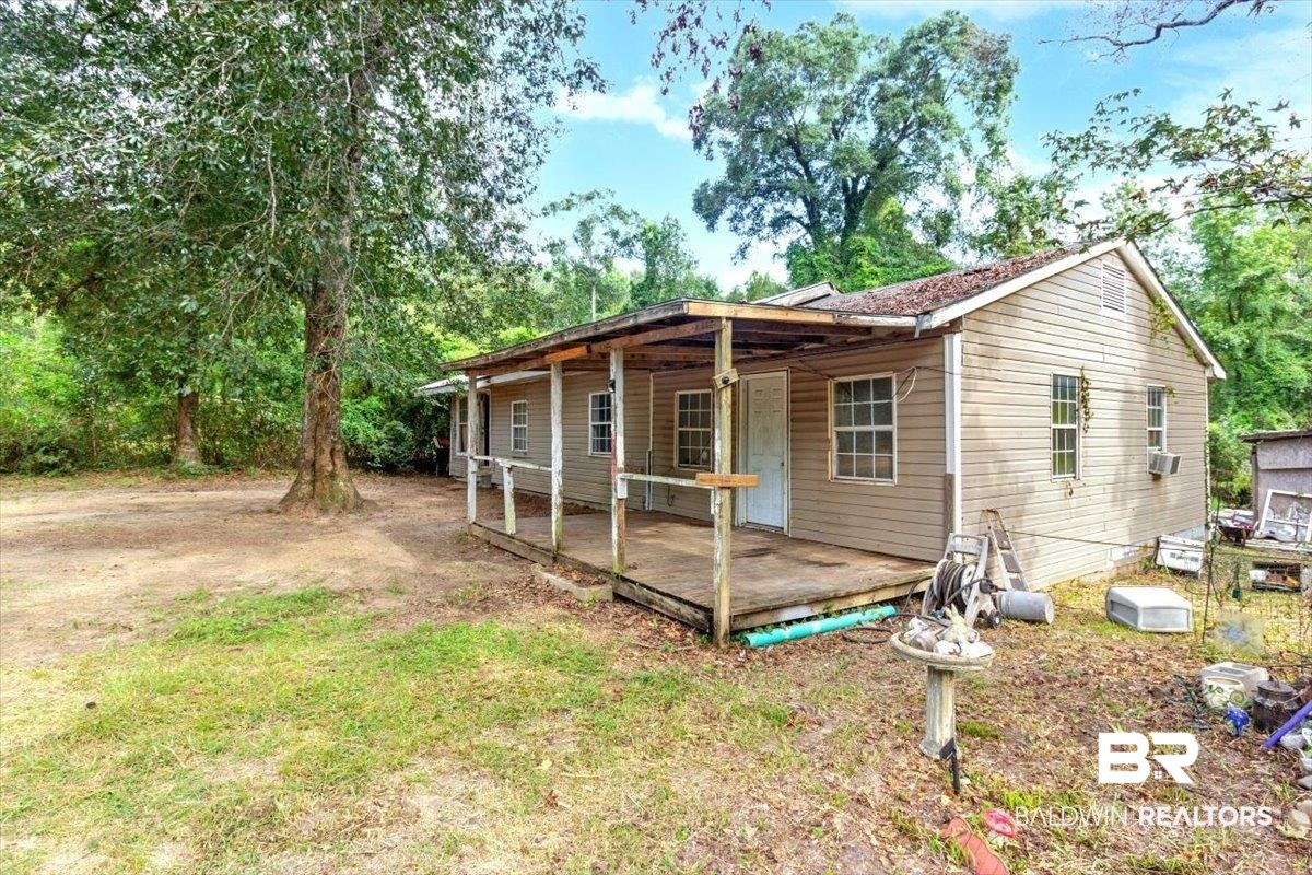 5386 Lott Road Eight Mile, AL 36613 - Photo 3 of 35 Back of house featuring a deck and a yard