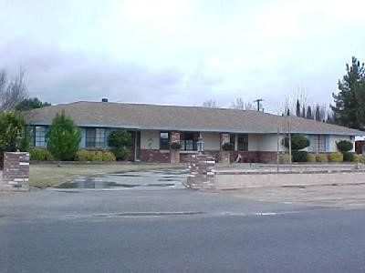14338 Tawya Road Apple Valley, CA 92307 - Photo 1 of 1 a front view of a house with a garden