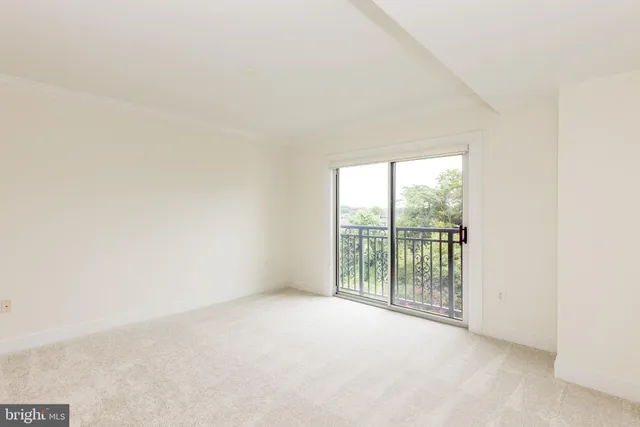 a view of an empty room with glass windows