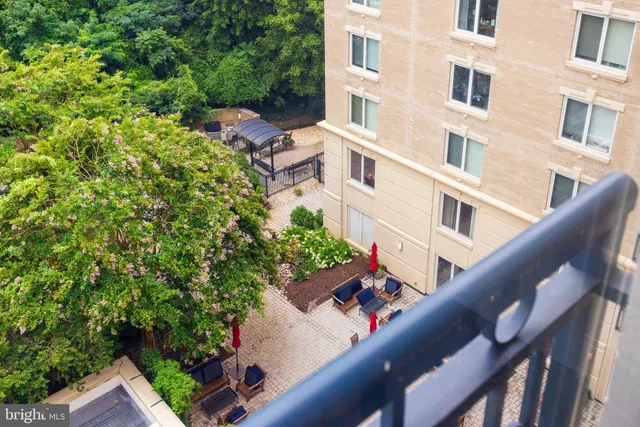 a balcony with outdoor seating and flowers