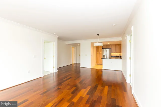 a view of an empty room and wooden floor