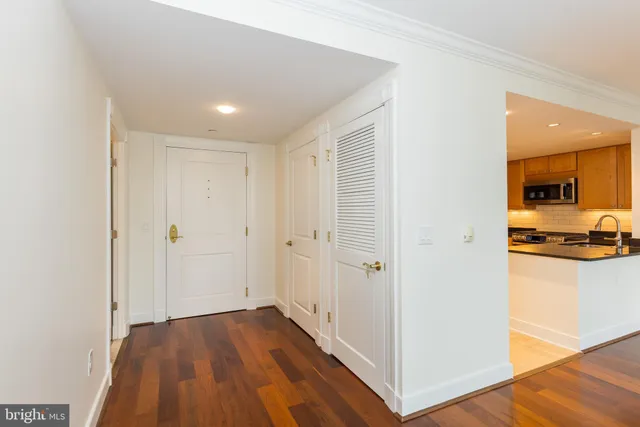 a view of a hallway with wooden floor