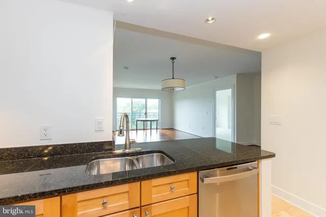 a kitchen with granite countertop a sink and a window