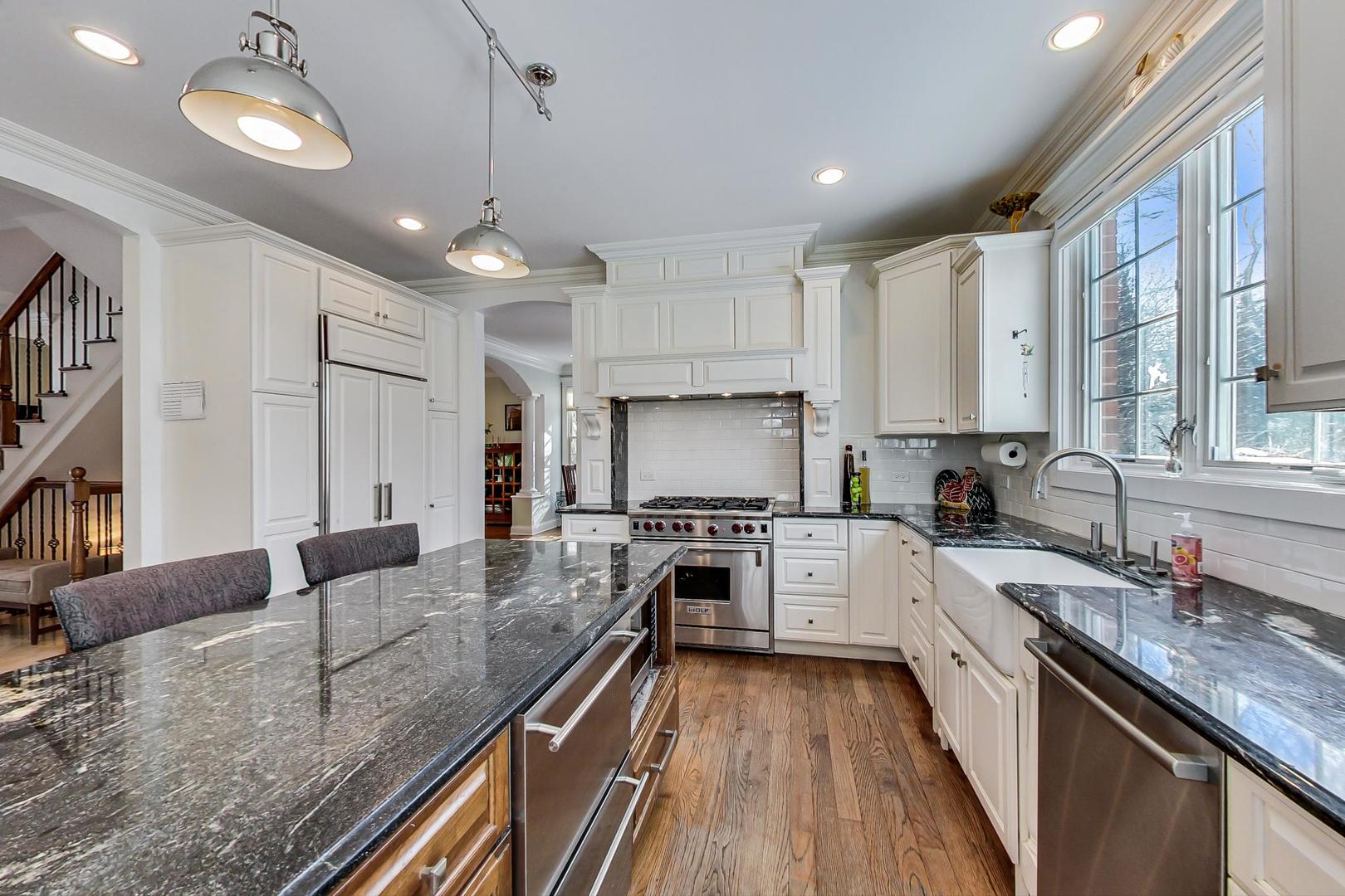 819 Redbud Lane Wilmette, IL 60091 - Photo 14 of 70 a large kitchen with granite countertop lots of counter space a sink stainless steel appliances and cabinets
