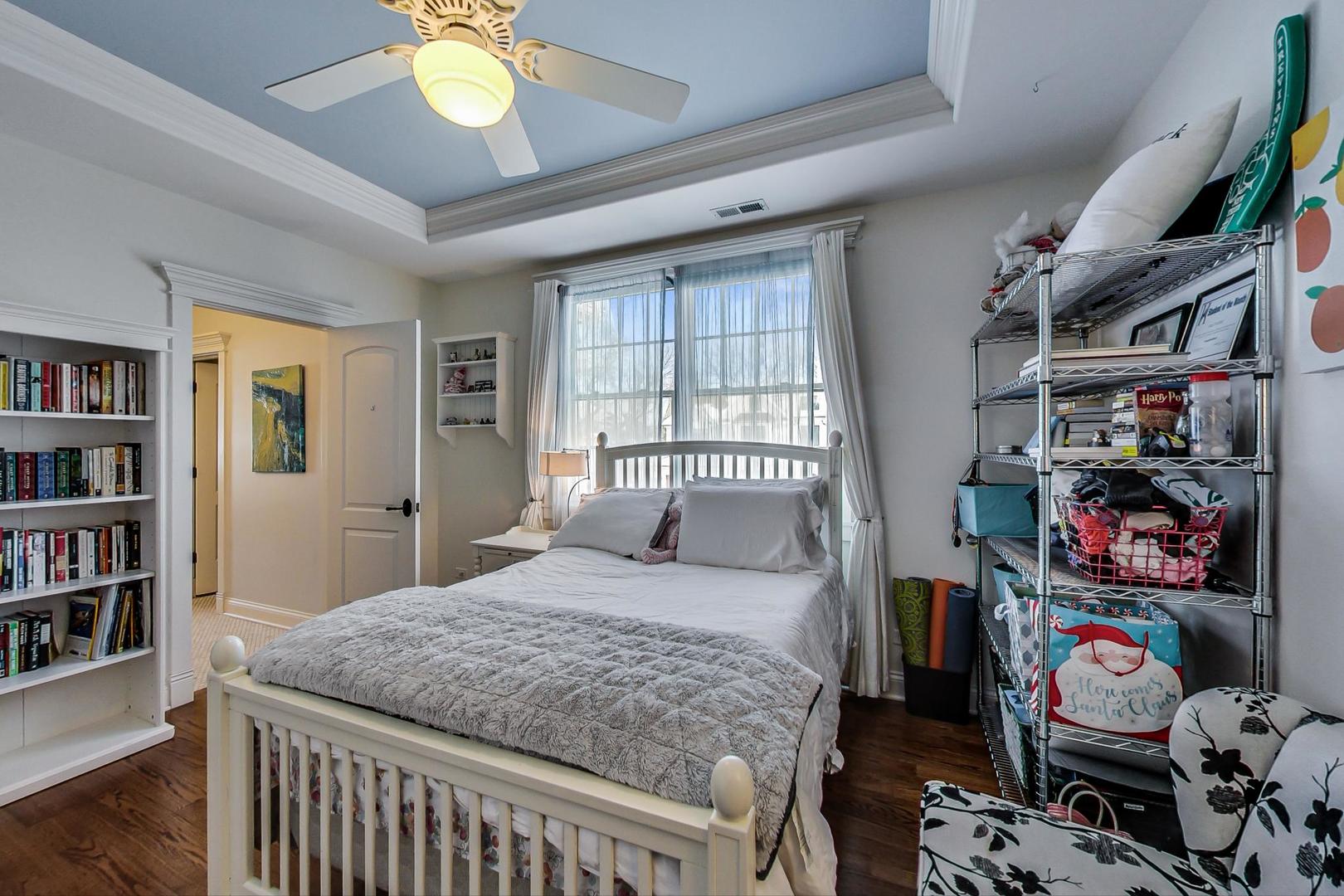 819 Redbud Lane Wilmette, IL 60091 - Photo 42 of 70 a bedroom with a bed and a book shelf
