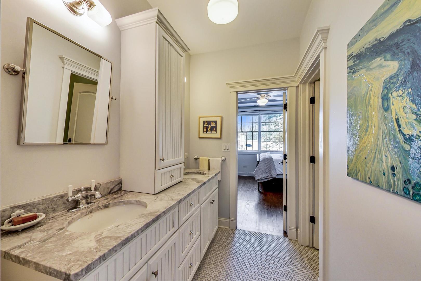 819 Redbud Lane Wilmette, IL 60091 - Photo 45 of 70 a en suite bathroom with a granite countertop sink and a mirror