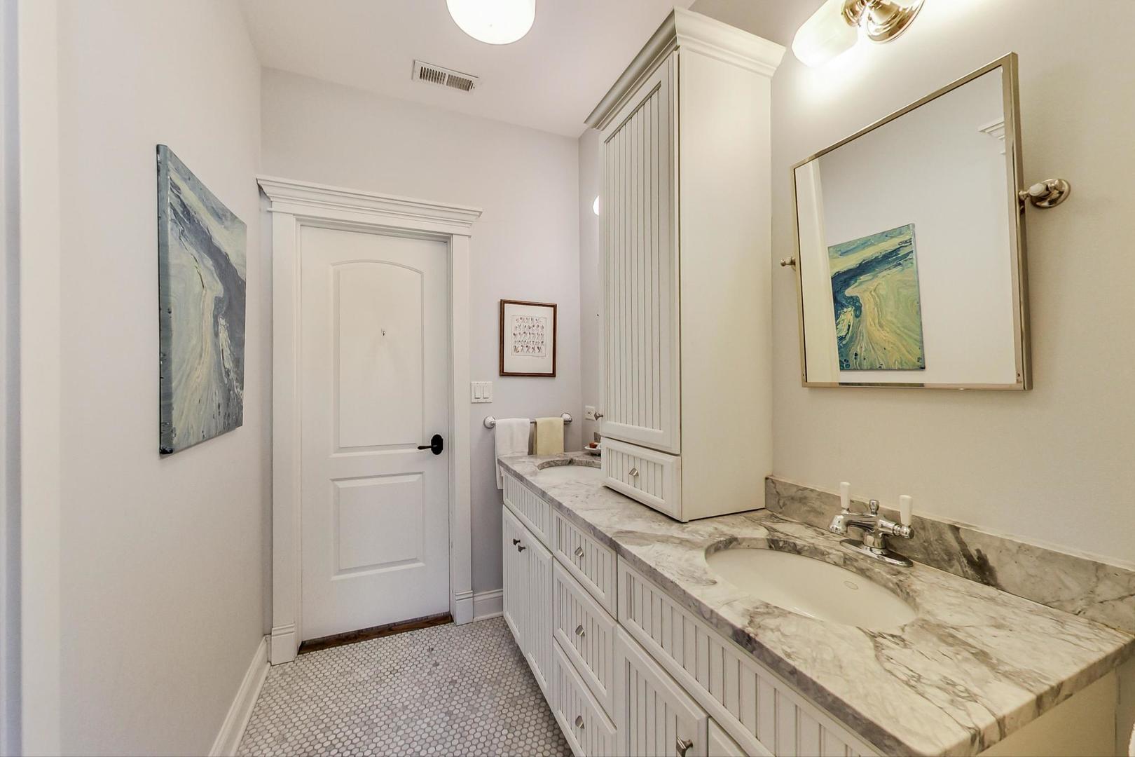 819 Redbud Lane Wilmette, IL 60091 - Photo 46 of 70 a bathroom with a granite countertop double vanity sink and a mirror