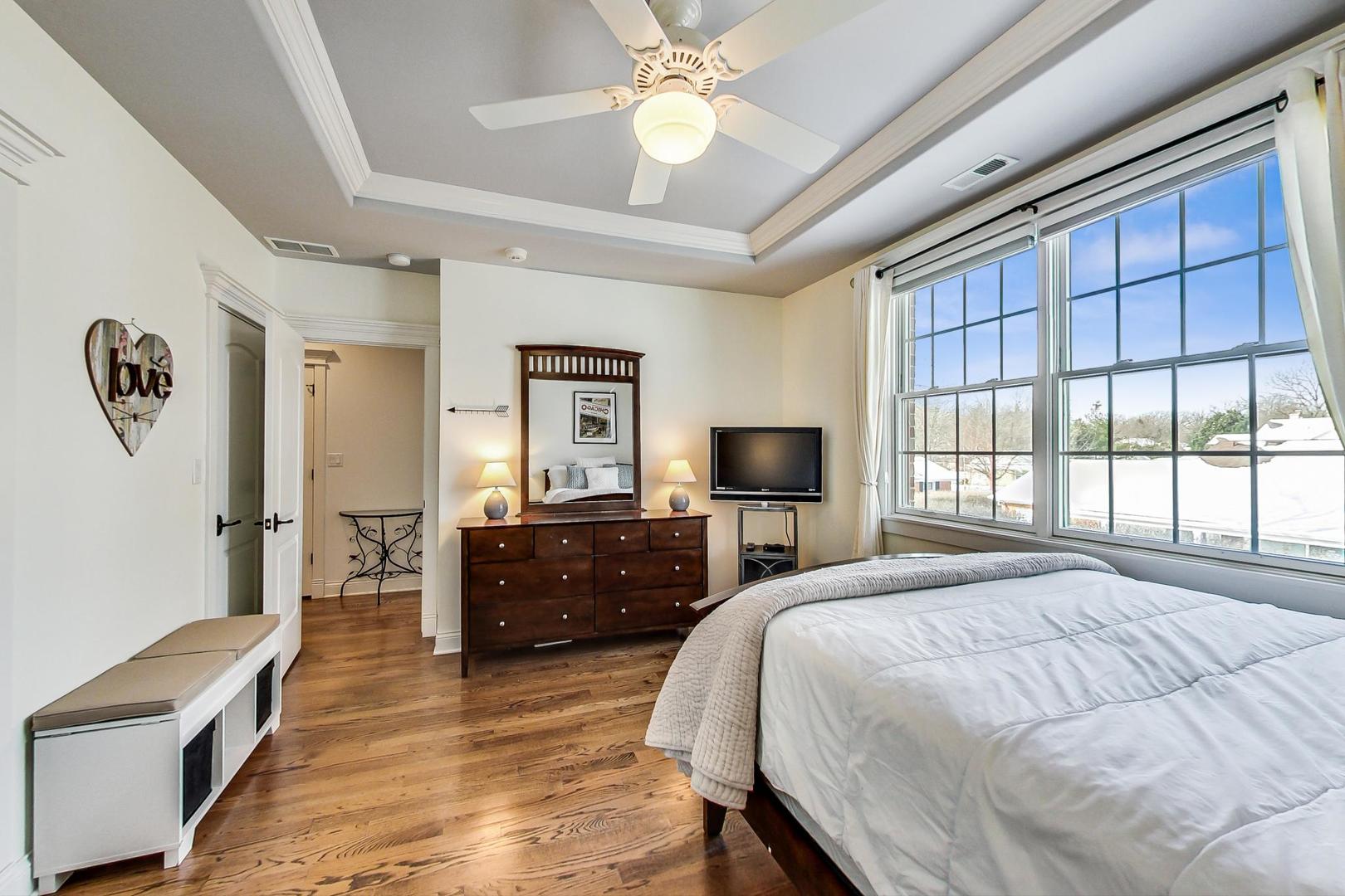 819 Redbud Lane Wilmette, IL 60091 - Photo 50 of 70 a bedroom with a bed and a chandelier